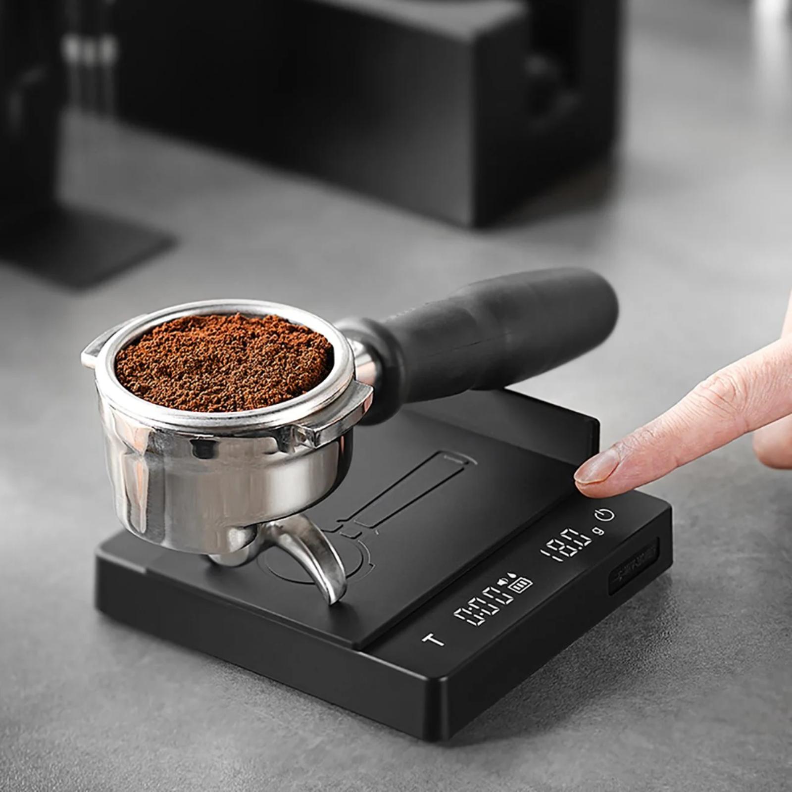 Coffee grinder with a digital display on a gray surface