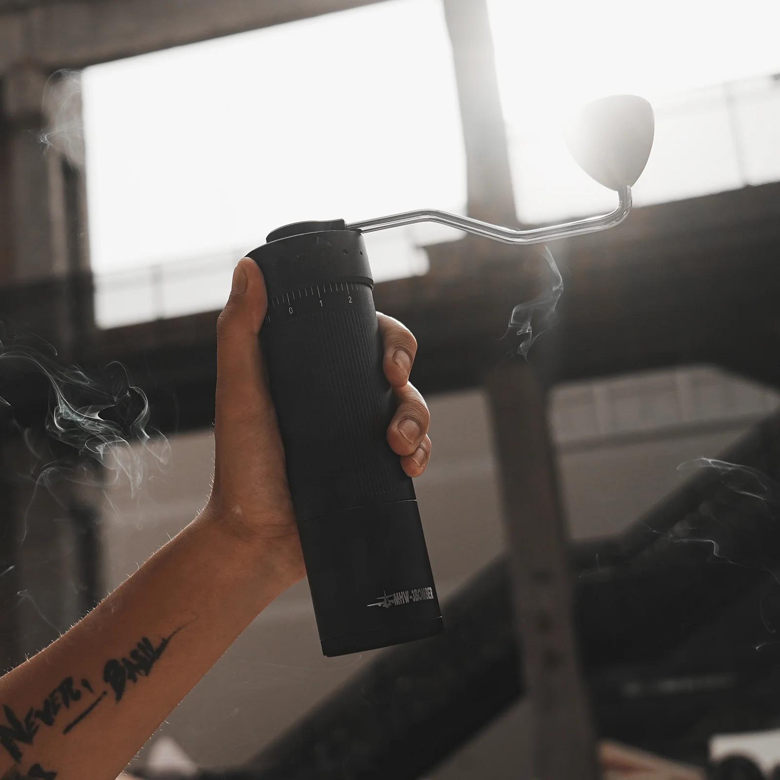 Hand holding a black spray can with smoke effect in an urban setting
